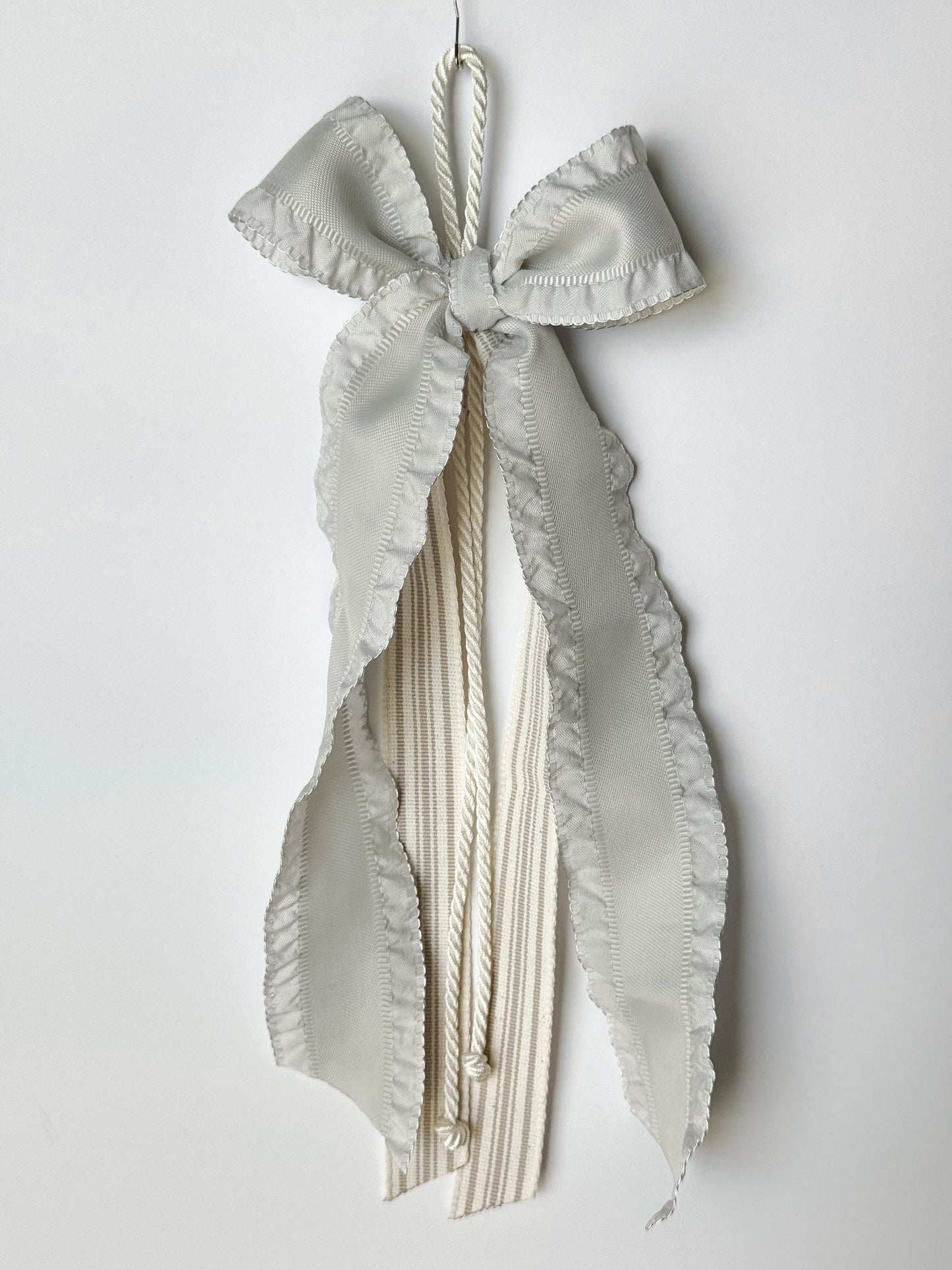 Ribbon Journal - Madison: 1.5in grey blue ruffle-edged ribbon with taupe striped natural canvas  center ribbons. $25 each. © Foshee Design Studio 2024