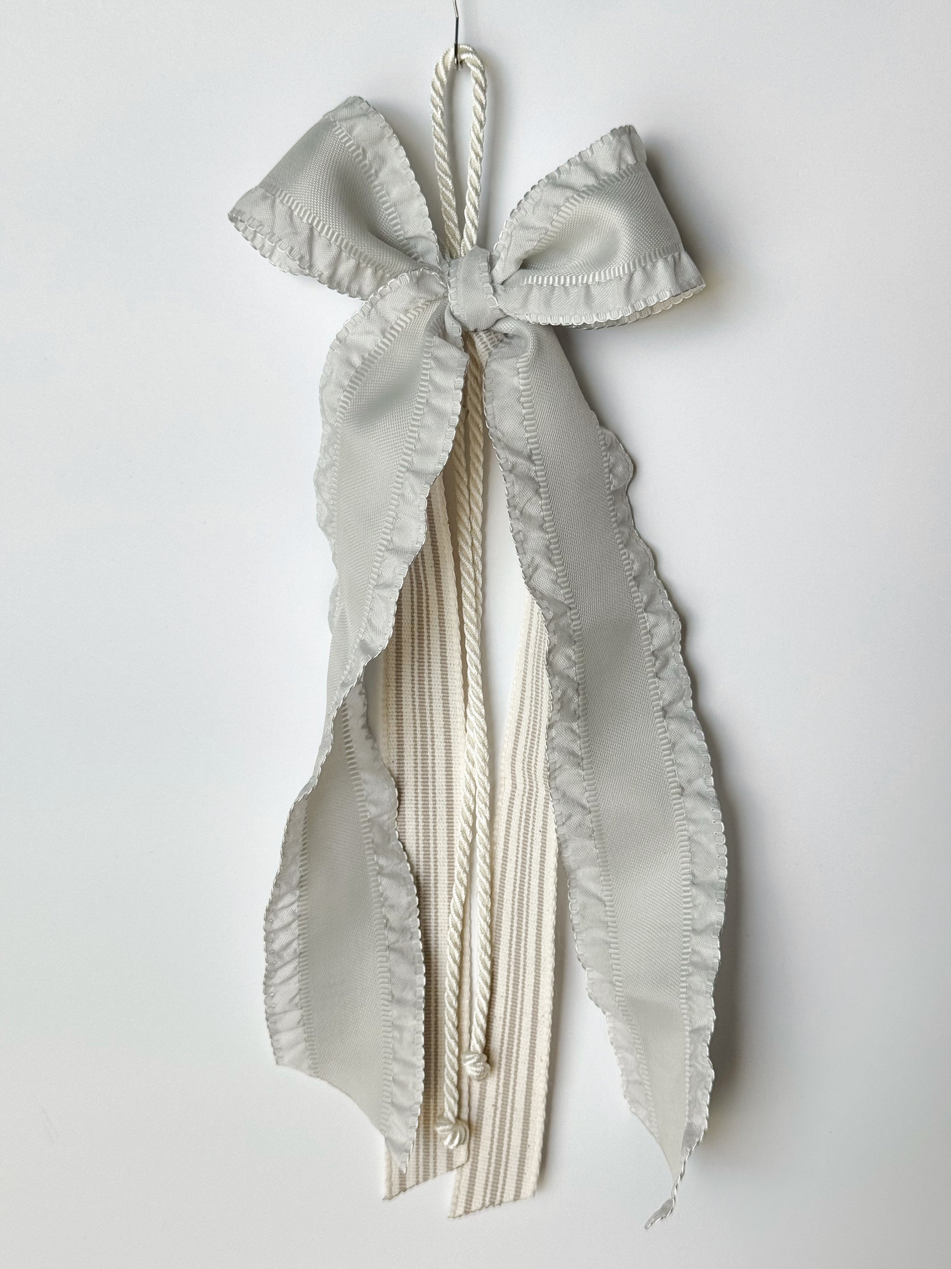 Ribbon Journal - Madison: 1.5in grey blue ruffle-edged ribbon with taupe striped natural canvas  center ribbons. $25 each. © Foshee Design Studio 2024