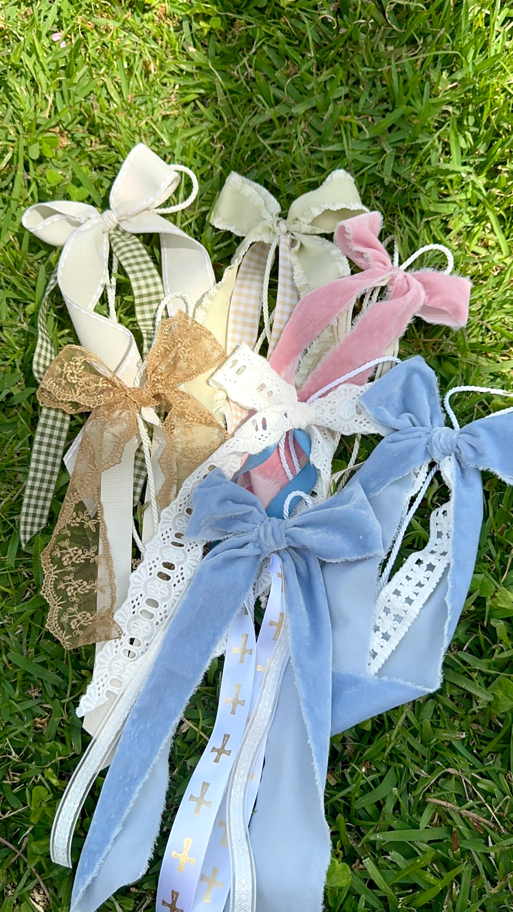 Collection of decorative bows with ribbons on a grass background